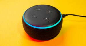 large, close-up on Alexa Voice device on branded yellow background